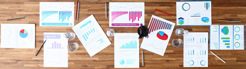 Paper with business chart on wooden office table closeup background. Finansial webinar concept. Site header mockup