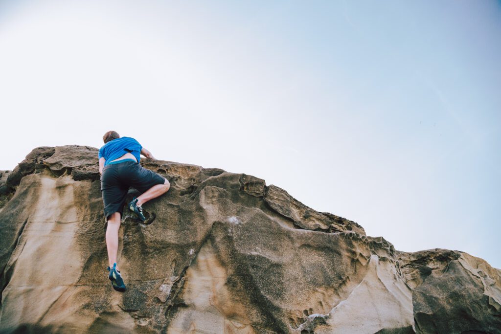 A men climbing a mountain to overcome his fears as a freelancer