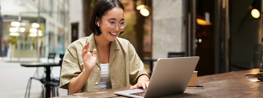 Freelancer with her laptop saying hello to her client