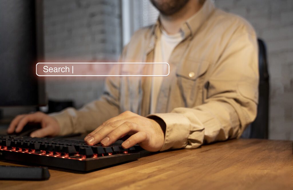 A men working in his computer, touching the keyboard